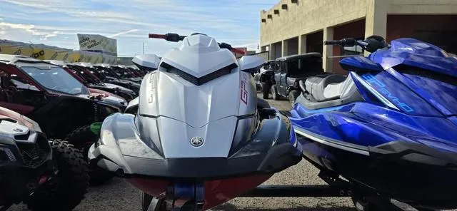 Slide: The Image of 2024 Yamaha Waverunner GP HO with Audio, silver and blue models, parked outdoors. - 4