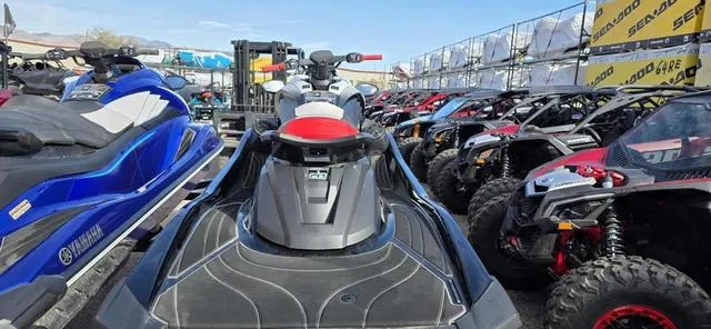 Slide: The Image of 2024 Yamaha Waverunner GP HO with Audio, parked among other vehicles, outdoor display. - 5