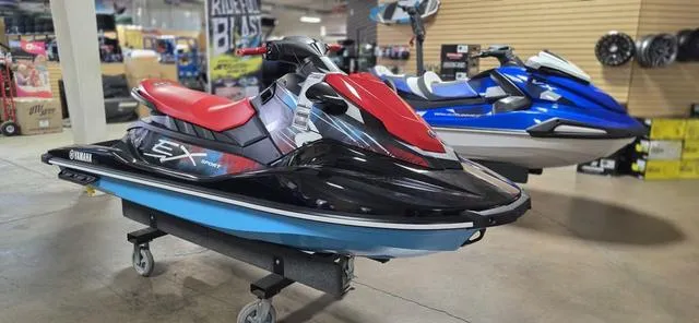 Slide: The Image of 2024 Yamaha Waverunner EX jet ski with red seat on display in showroom. - 3