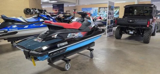 Slide: The Image of 2024 Yamaha Waverunner EX jet ski displayed in showroom with off-road vehicle nearby. - 5