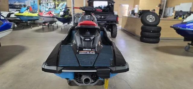 Slide: The Image of 2024 Yamaha Waverunner EX in showroom, rear view with other watercrafts visible. - 6