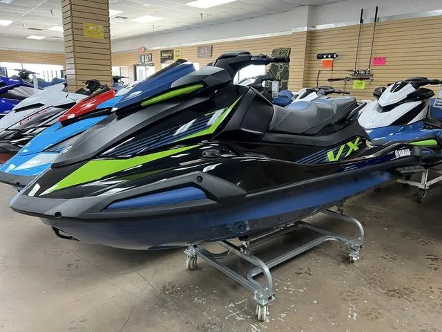 Slide: The Image of 2024 Yamaha Waverunner VX jet ski displayed in showroom, featuring sleek black and green design. - 5