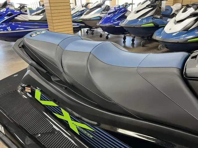 Slide: The Image of 2024 Yamaha Waverunner VX jet ski in showroom, featuring sleek black and blue design. - 6