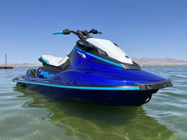 Slide: The Image of 2024 Yamaha Waverunner Jetblaster on calm water, showcasing sleek blue design. - 2