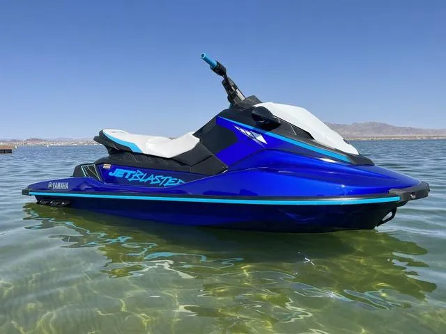 Slide: The Image of 2024 Yamaha Waverunner Jetblaster in blue, floating on clear water under a sunny sky. - 5