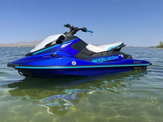 Slide: The Image of 2024 Yamaha Waverunner Jetblaster in blue, floating on clear water under a sunny sky. - 6