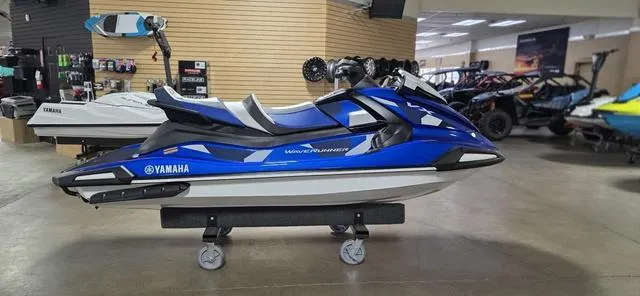 Slide: The Image of 2024 Yamaha Waverunner VX Cruiser HO with Audio in showroom, blue and white design. - 3