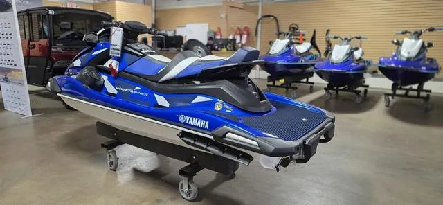 Slide: The Image of 2024 Yamaha Waverunner VX Cruiser HO with Audio in showroom, blue and black design. - 6