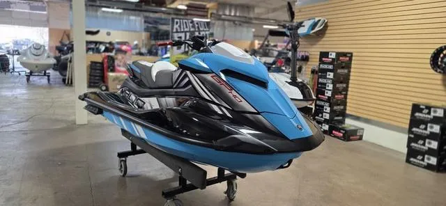 Slide: The Image of 2024 Yamaha Waverunner GP in showroom, blue and black design, on display stand. - 6