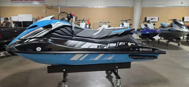 Slide: The Image of 2024 Yamaha Waverunner GP in showroom, sleek blue and black design, side view. - 7