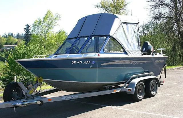 Slide: The Image of 2008 Fish Rite 20 Performer boat on trailer in a parking lot. - 1