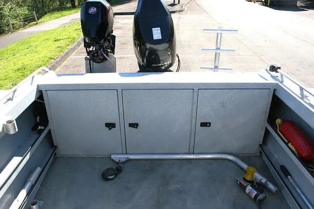 Slide: The Image of 2008 Fish Rite 20 Performer boat interior with storage compartments and dual outboard motors. - 10