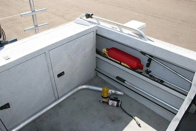 Slide: The Image of Interior of a 2008 Fish Rite 20 Performer boat showing storage compartments and equipment. - 11