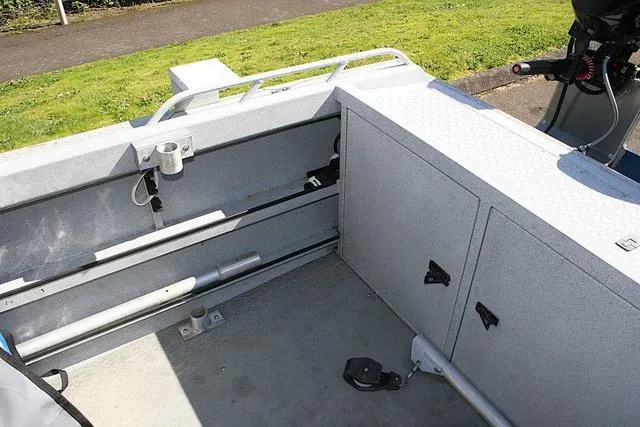 Slide: The Image of 2008 Fish Rite 20 Performer boat interior with storage compartments and fishing rod holders. - 12