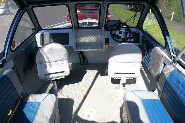 Slide: The Image of Interior of a 2008 Fish Rite 20 Performer boat with seating and steering wheel. - 5