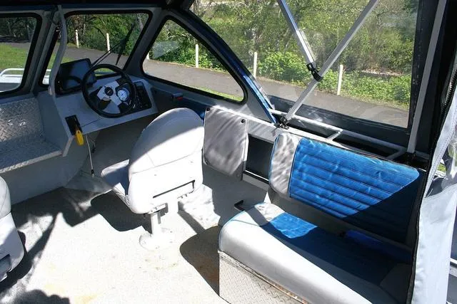 Slide: The Image of 2008 Fish Rite 20 Performer boat interior with steering wheel and seating. - 6