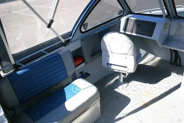 Slide: The Image of 2008 Fish Rite 20 Performer boat interior with blue seating and steering console. - 7