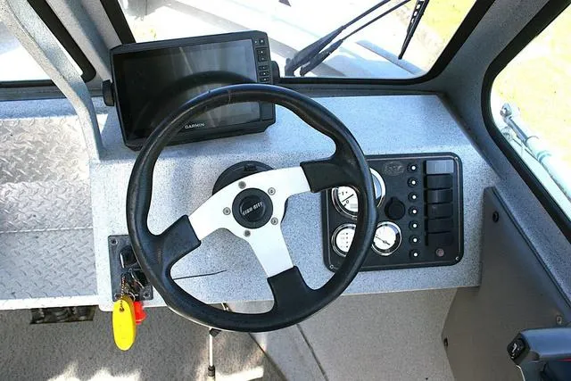 Slide: The Image of 2008 Fish Rite 20 Performer boat dashboard with steering wheel and Garmin display. - 8