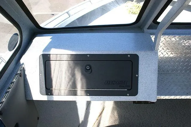 Slide: The Image of 2008 Fish Rite 20 Performer boat interior with storage compartment and diamond plate flooring. - 9