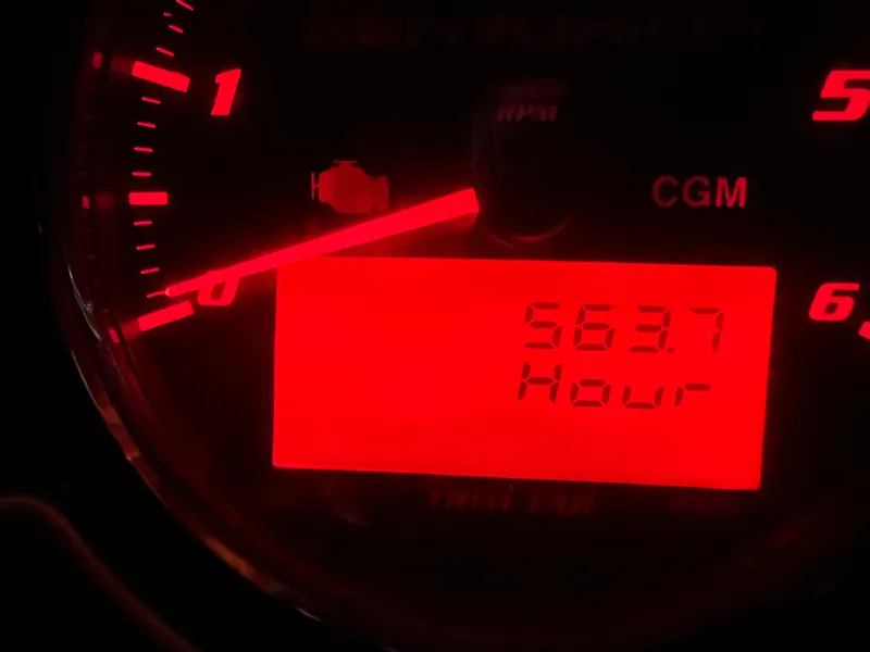 Slide: The Image of 2016 Centurion Carbon Pro tachometer displaying 563.7 hours in red lighting. - 13