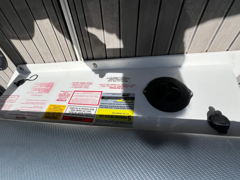 Slide: The Image of 2016 Centurion Carbon Pro boat dashboard with warning labels and controls. - 19