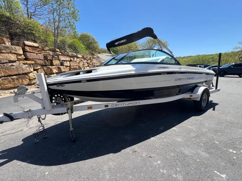Slide: The Image of 2016 Centurion Carbon Pro boat on trailer, parked outdoors on a sunny day. - 2