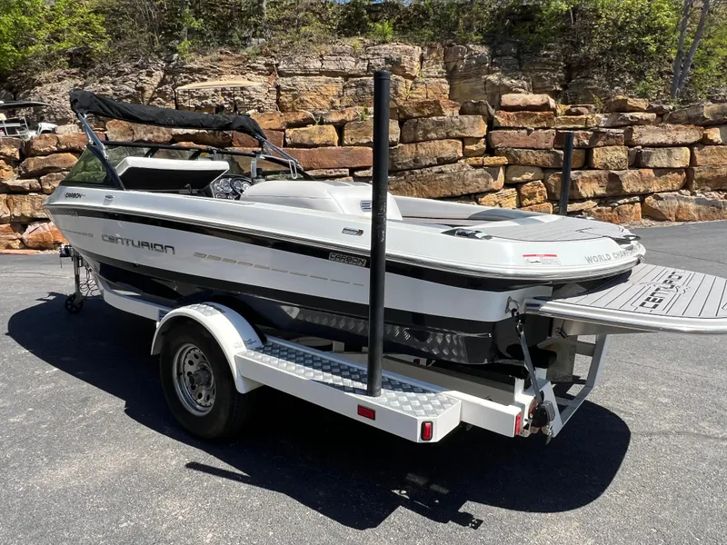 Slide: The Image of 2016 Centurion Carbon Pro boat on trailer, parked outdoors near stone wall. - 3