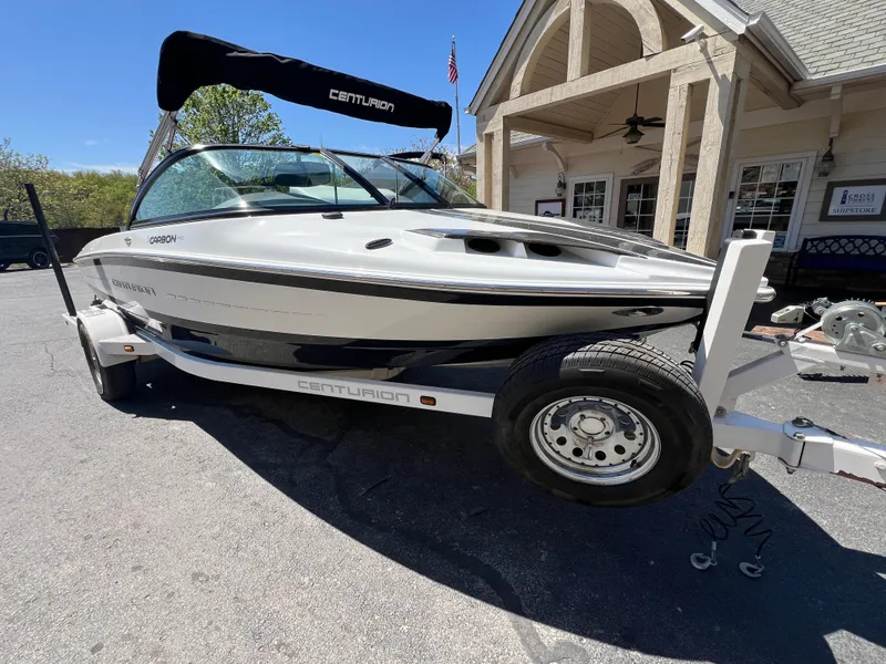 Slide: The Image of 2016 Centurion Carbon Pro boat on trailer, parked near a building. - 4