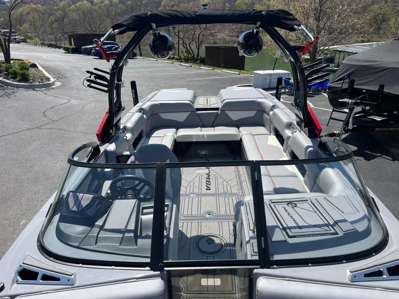 Slide: The Image of 2022 Moomba Makai boat with spacious seating and sleek design, parked outdoors. - 13