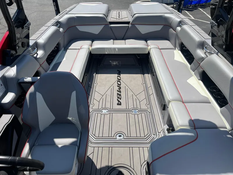 Slide: The Image of 2022 Moomba Makai boat interior with gray seating and Moomba-branded flooring. - 15