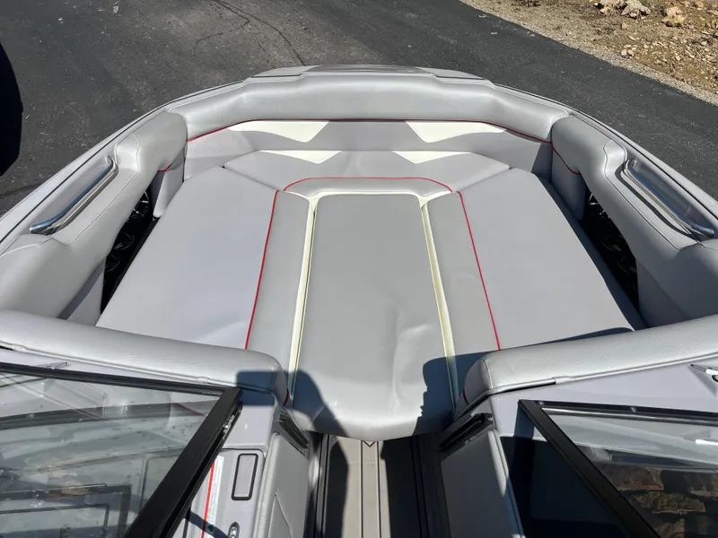 Slide: The Image of 2022 Moomba Makai boat interior with gray seating and red accents. - 17