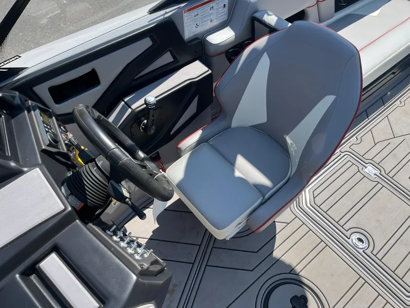 Slide: The Image of 2022 Moomba Makai boat interior with steering wheel and gray captain's seat. - 18