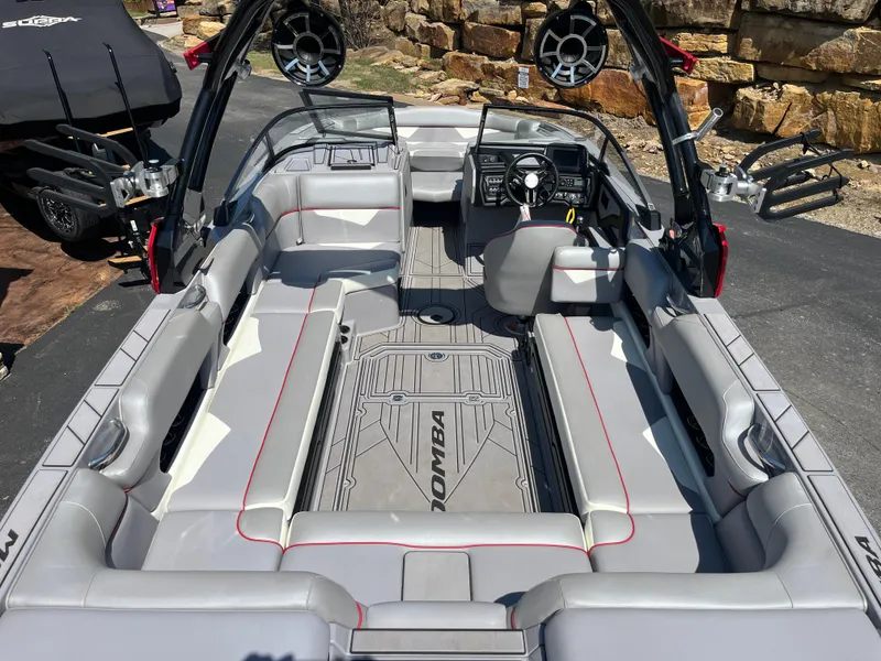 Slide: The Image of 2022 Moomba Makai boat interior with gray seating and advanced dashboard features. - 19