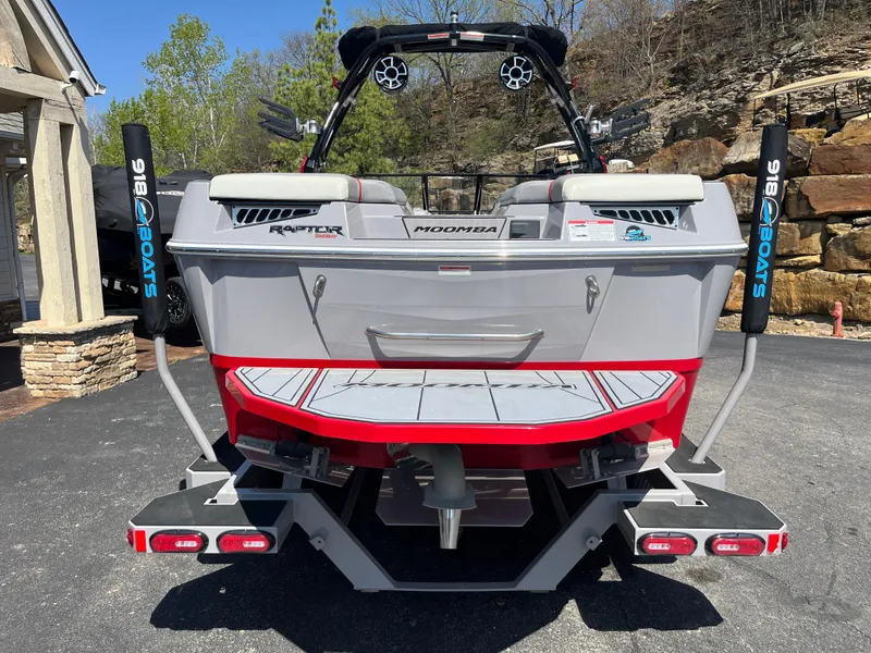 Slide: The Image of 2022 Moomba Makai boat rear view with Raptor engine, parked outdoors. - 6