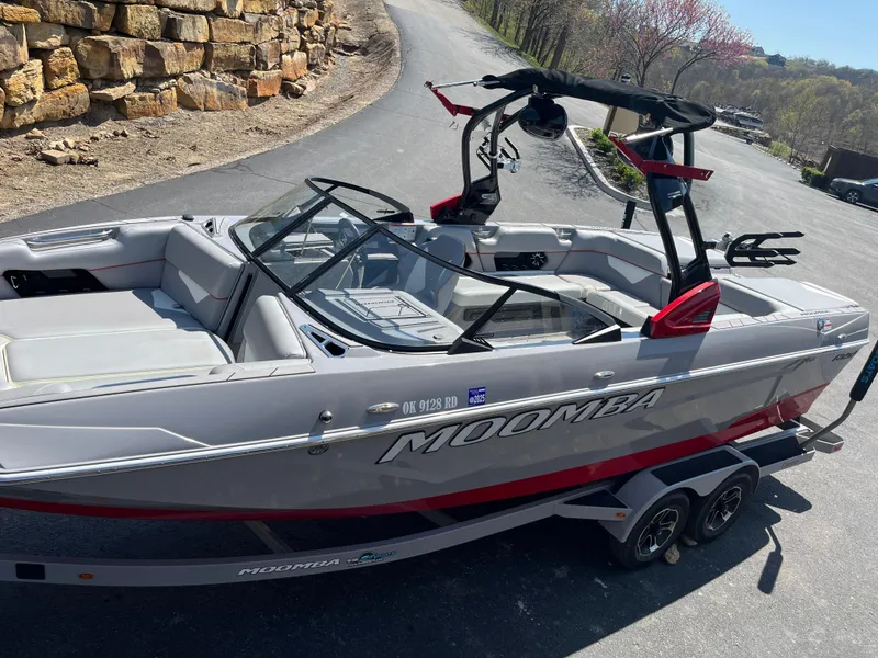 Slide: The Image of 2022 Moomba Makai boat on trailer, parked on a scenic road. - 7