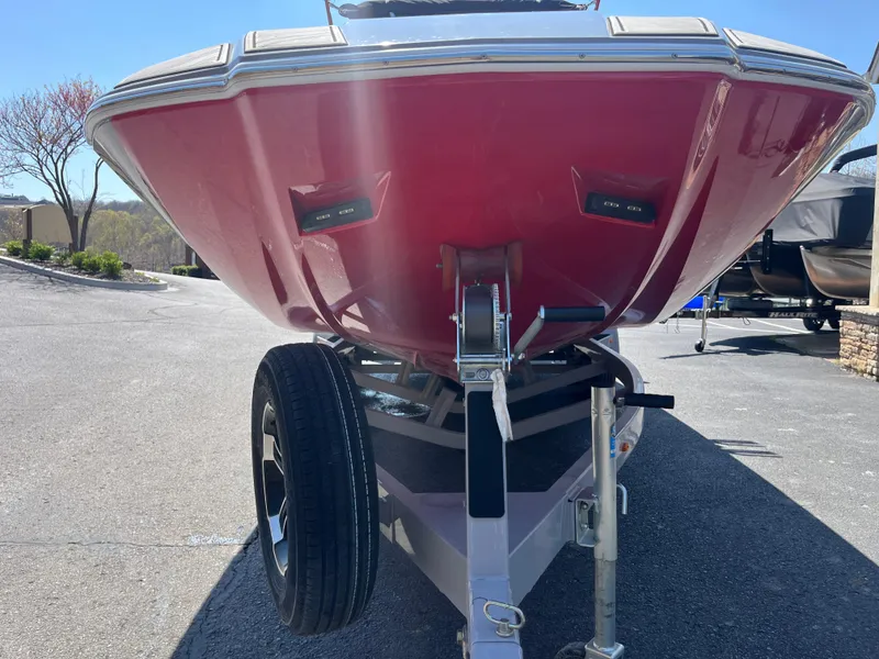 Slide: The Image of 2022 Moomba Makai boat on trailer, red hull, parked outdoors. - 8