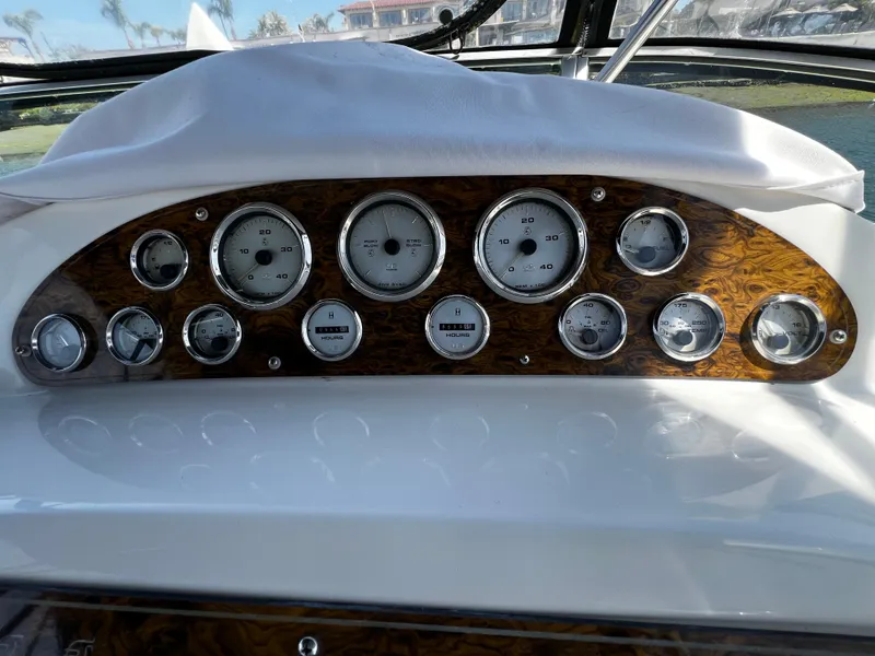 Slide: The Image of Dashboard of 2001 Bayliner 3488 Command Bridge Motoryacht with gauges and wood paneling. - 11