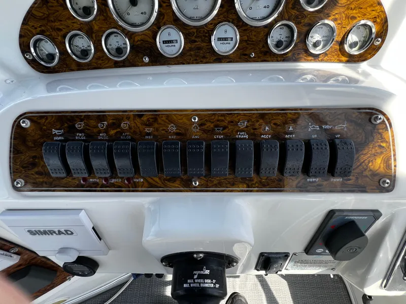 Slide: The Image of Control panel of a 2001 Bayliner 3488 Command Bridge Motoryacht with switches and gauges. - 12