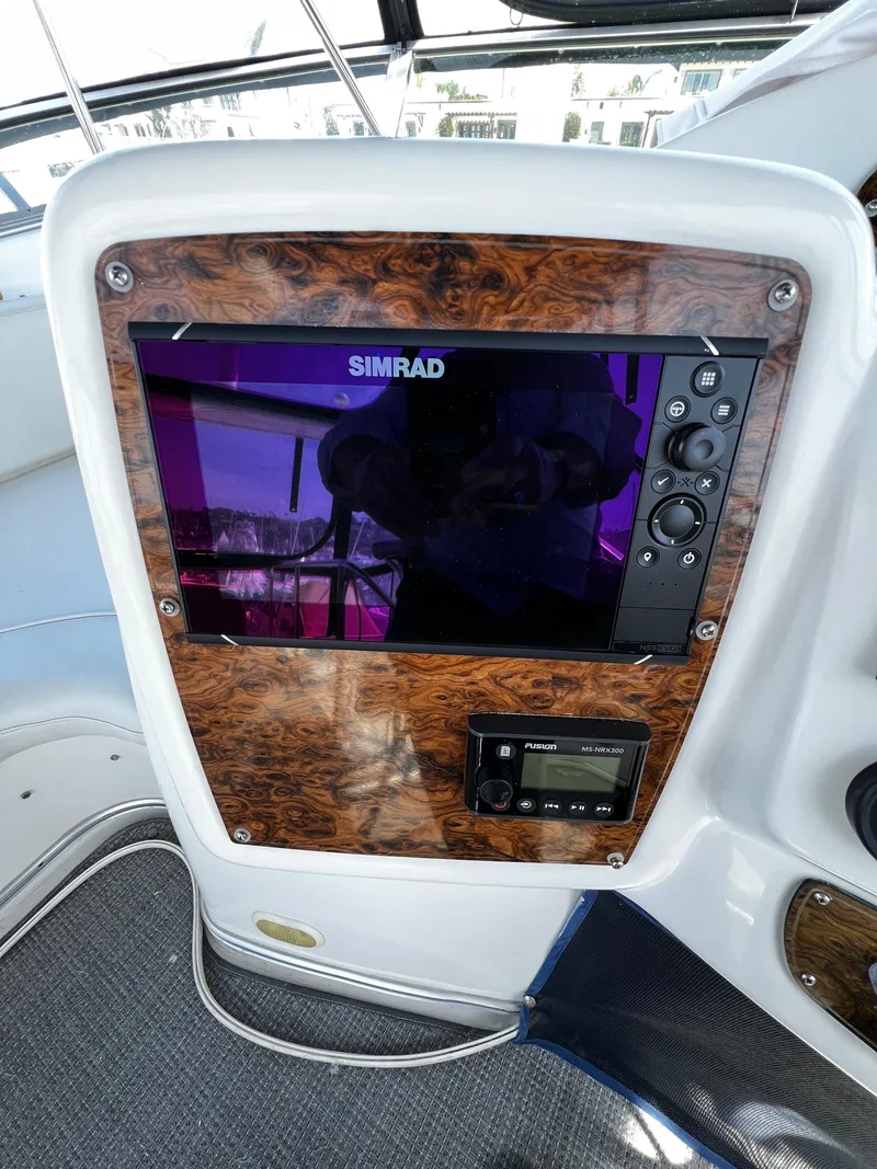 Slide: The Image of 2001 Bayliner 3488 Command Bridge Motoryacht dashboard with Simrad navigation system. - 13