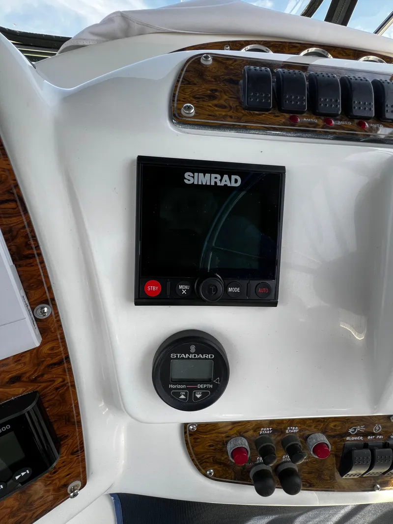 Slide: The Image of 2001 Bayliner 3488 Command Bridge Motoryacht dashboard with Simrad navigation system. - 14