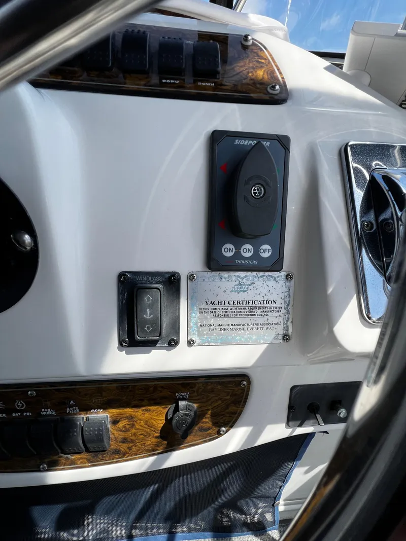 Slide: The Image of 2001 Bayliner 3488 Command Bridge Motoryacht dashboard with controls and certification plaque. - 16