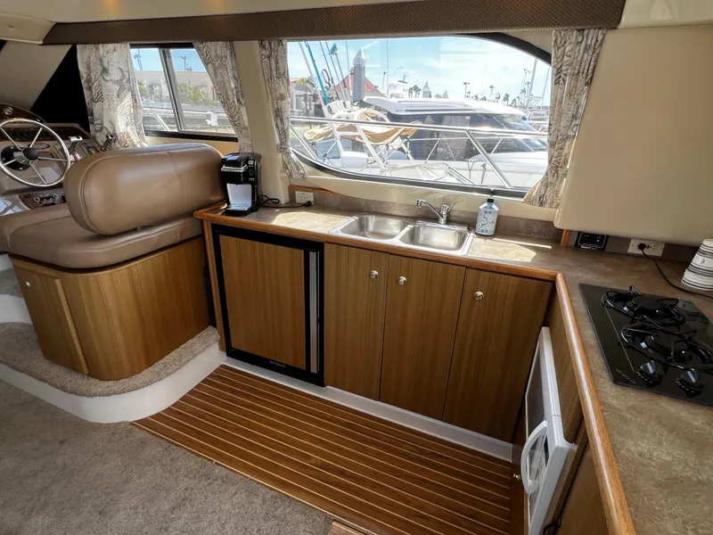 Slide: The Image of Interior of 2001 Bayliner 3488 Command Bridge Motoryacht with kitchenette and seating area. - 19