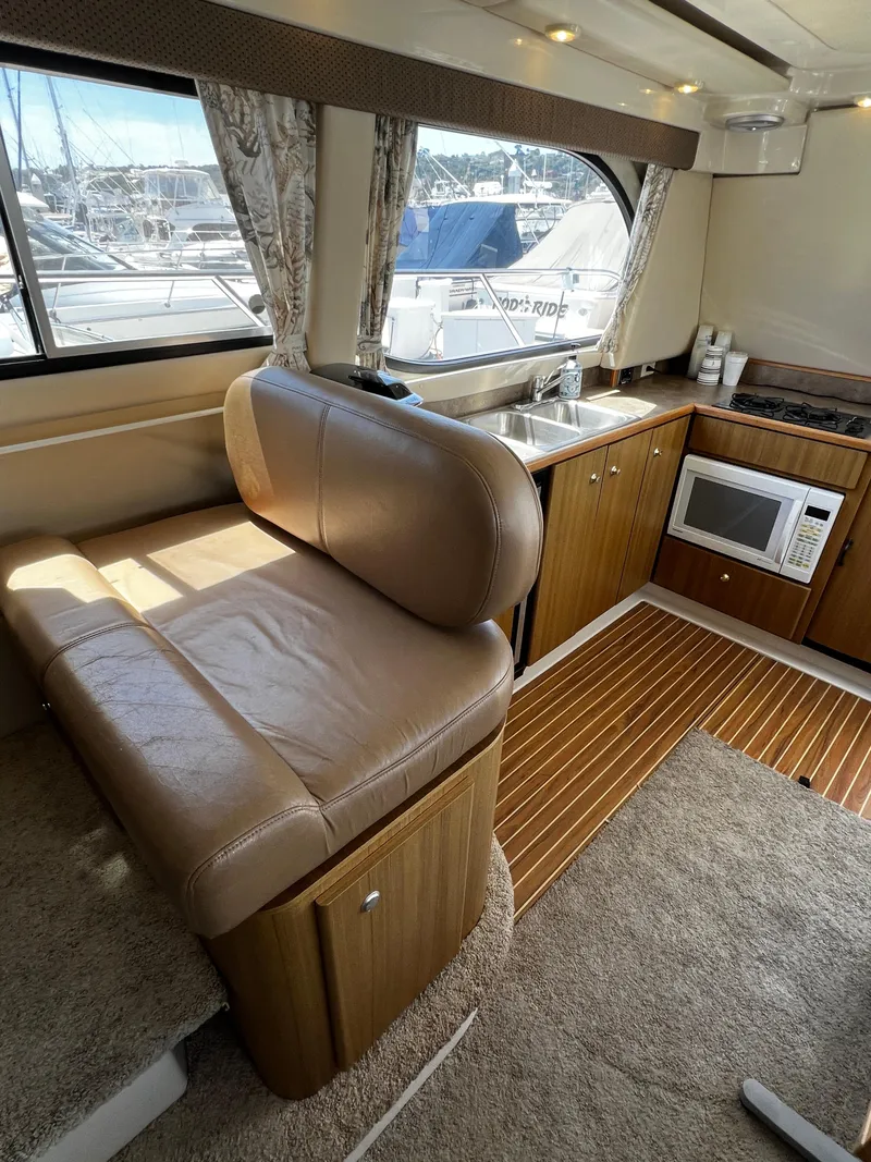 Slide: The Image of Interior of 2001 Bayliner 3488 Command Bridge Motoryacht with seating, kitchenette, and window view. - 20