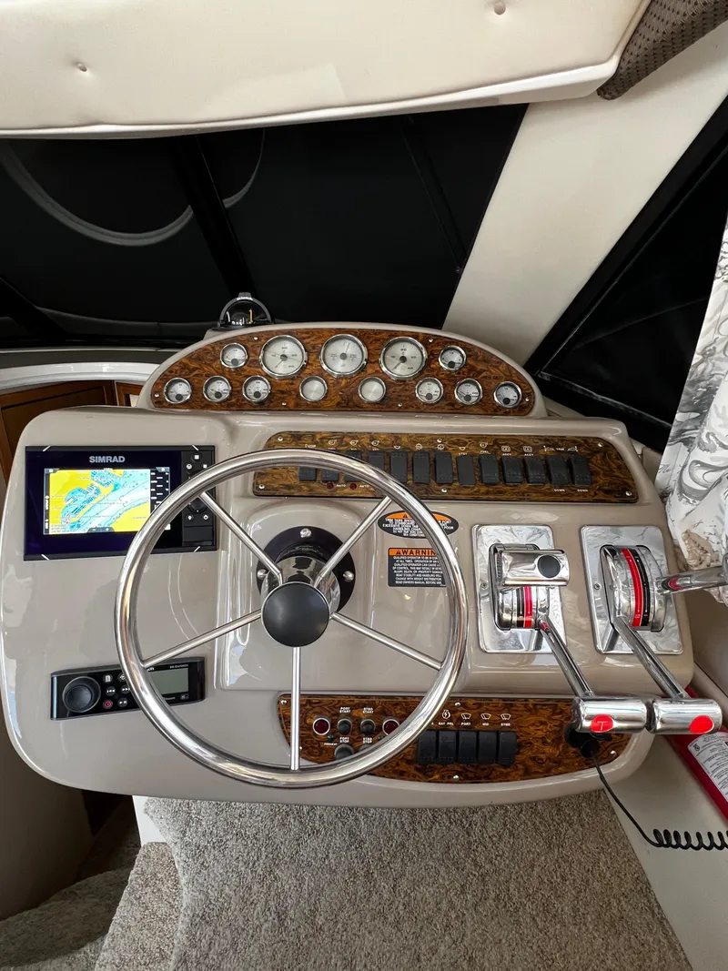 Slide: The Image of 2001 Bayliner 3488 Command Bridge Motoryacht helm with gauges, GPS, and controls. - 21