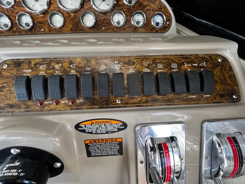 Slide: The Image of 2001 Bayliner 3488 Command Bridge Motoryacht dashboard with switches and gauges. - 22