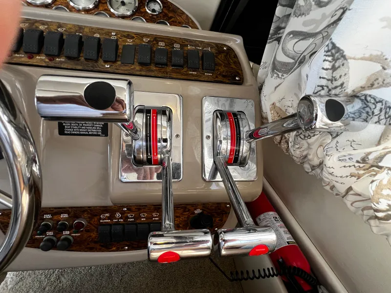 Slide: The Image of Control panel of a 2001 Bayliner 3488 Command Bridge Motoryacht with throttle levers. - 23