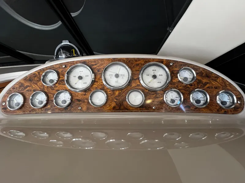 Slide: The Image of Dashboard of 2001 Bayliner 3488 Command Bridge Motoryacht with wood finish and multiple gauges. - 24
