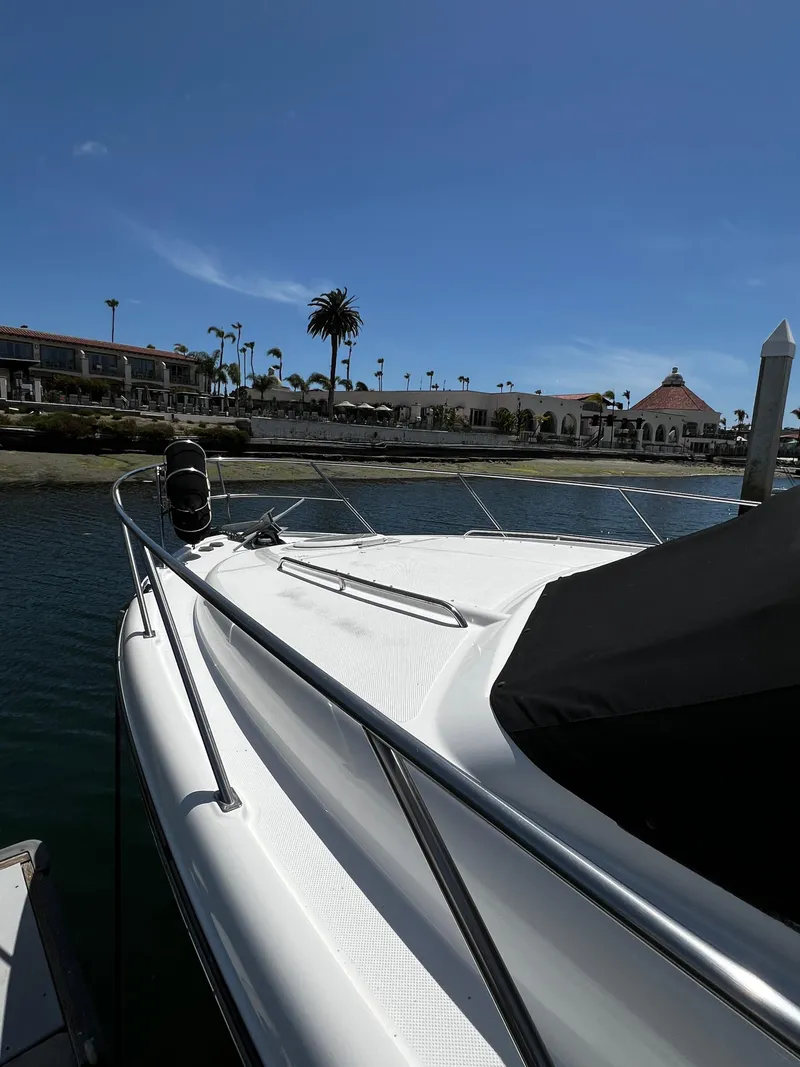 Slide: The Image of 2001 Bayliner 3488 Command Bridge Motoryacht docked near waterfront buildings. - 3