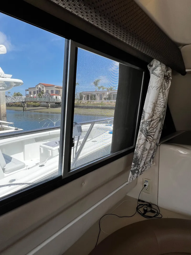 Slide: The Image of Interior view from a 2001 Bayliner 3488 Command Bridge Motoryacht, showing a window overlooking a marina. - 37