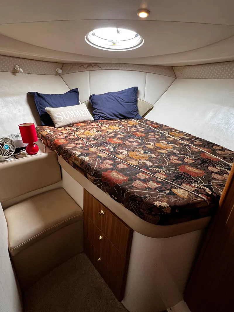 Slide: The Image of 2001 Bayliner 3488 Command Bridge Motoryacht cabin with cozy bed and floral bedding. - 39